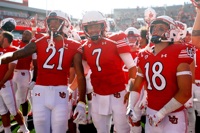 Utah Utes quarterback Cameron Rising (7), center, celebrates with his teammates after their win against the Washington State Cougars.